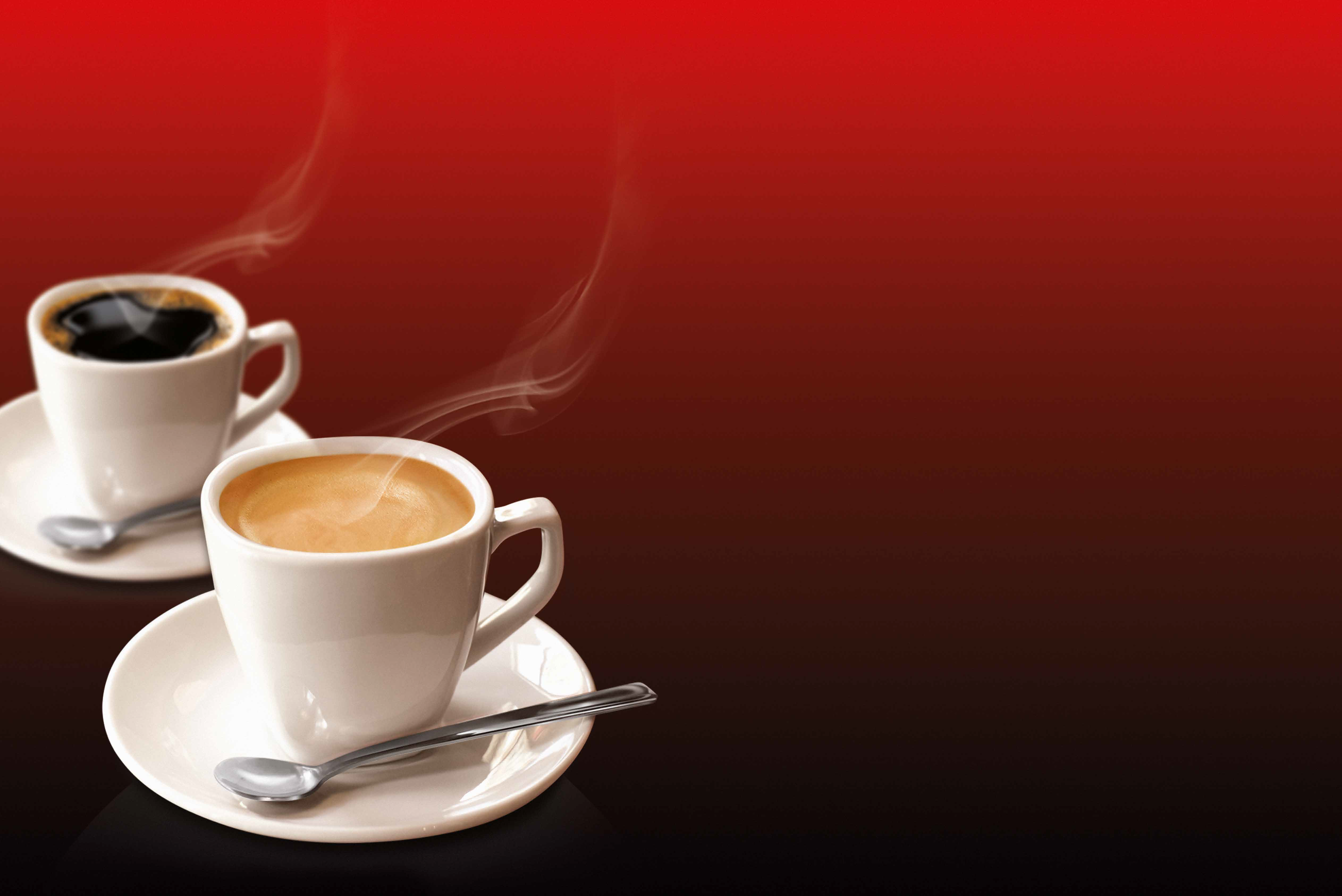 Banner with two steaming cups of coffe on a plain red backround.