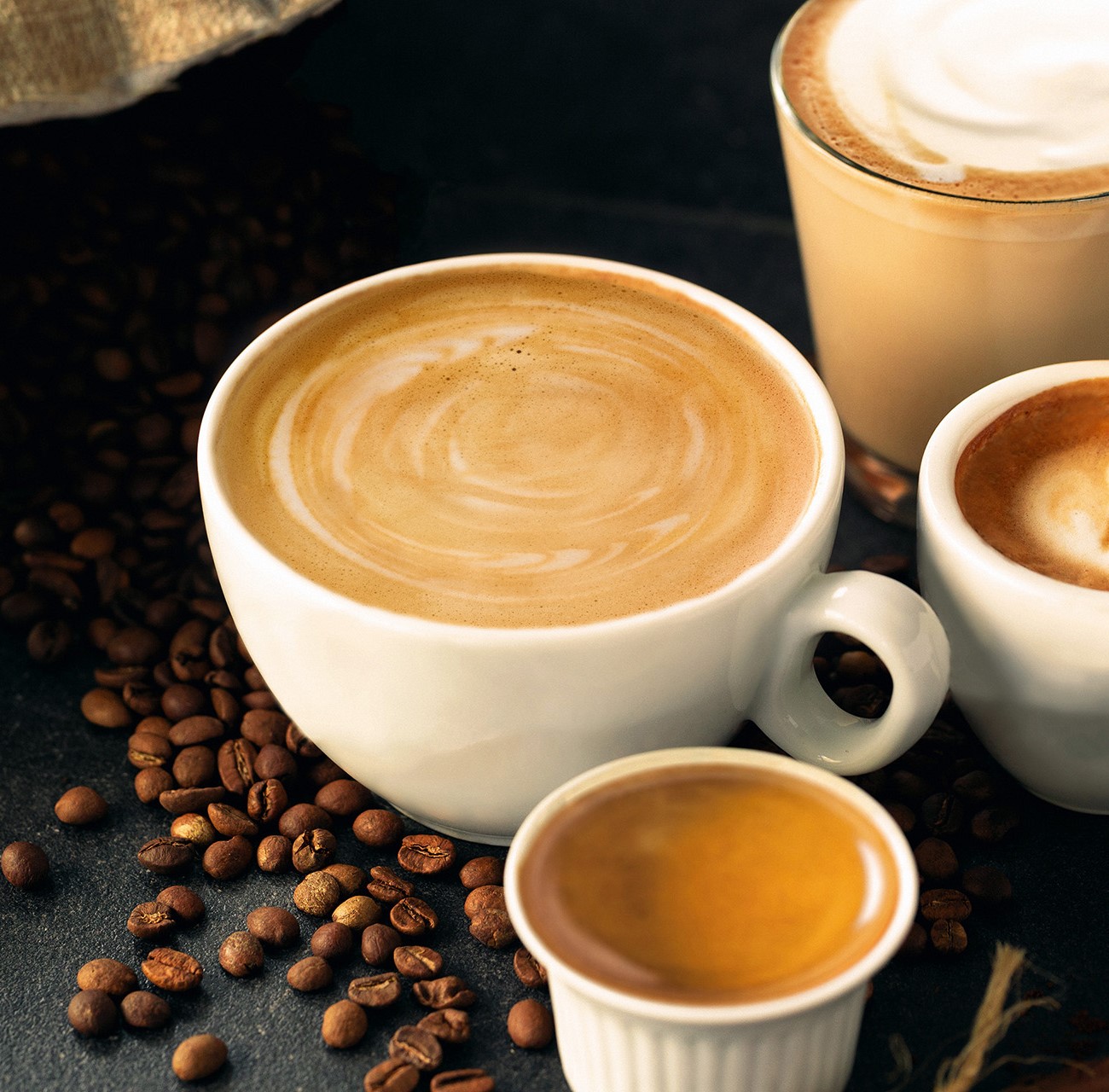 Multiple cups of coffee on a table.