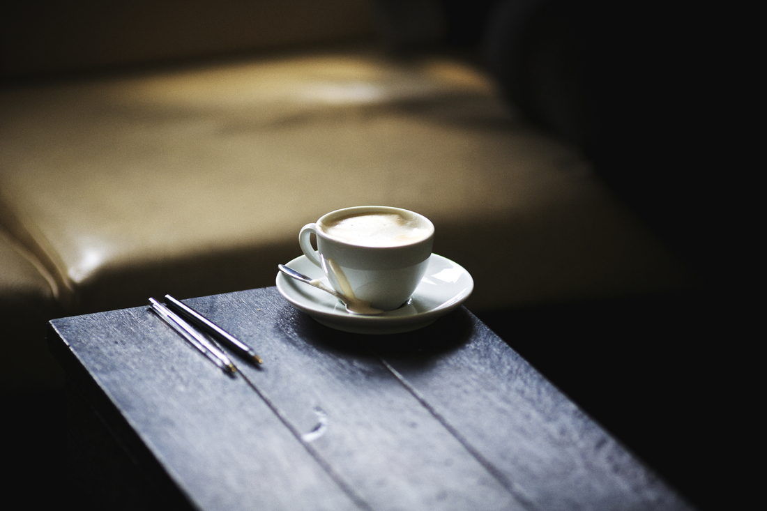 A cup of espresso macchiato on a wood