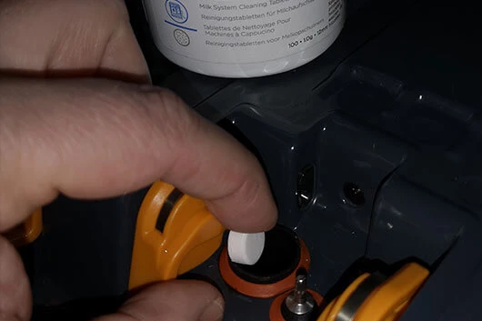 Die Reinigungstabletten werden in die L'OR Promesso eingeworfen